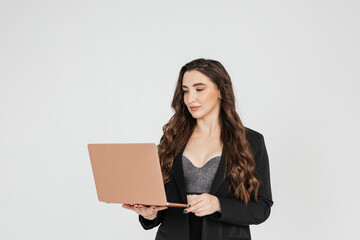 Young businesswoman using laptop against white background, copy space