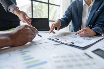 Asian business people brainstorming in a graph analytical computing plan meeting. data chart Marketing growth. Finance. The concept of business success statistics.