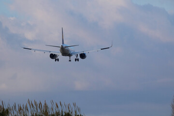 Commercial aircraft overflying the sky and arriving at airport