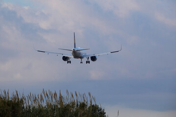 Commercial aircraft overflying the sky and arriving at airport
