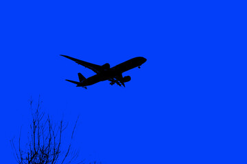 Commercial aircraft overflying the sky and arriving at airport