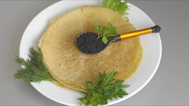 Pancakes with black caviar, cooked for Maslenitsa. Maslenitsa is an East Slavic traditional holiday celebrated during the week before Lent.