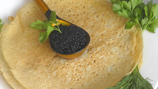 Pancakes with black caviar, cooked for Maslenitsa. Maslenitsa is an East Slavic traditional holiday celebrated during the week before Lent.