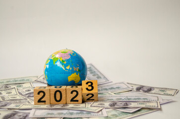 close-up stack of coins, 2023 wooden text block  on the table, saving and managing money for transport, transportation insurance business technology, economic crisis risk and problem concept