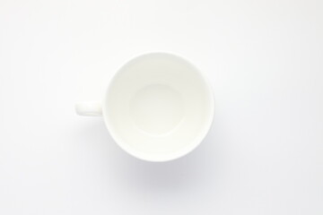 white cup on white surface