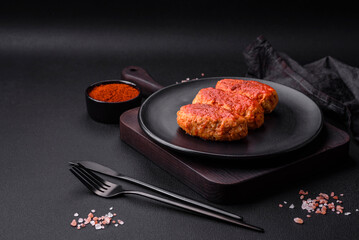 Meat cutlet or meatballs in tomato sauce with garlic, salt, spices and herbs