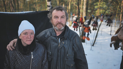 Homeless people are interviewed in the winter in the woods.
