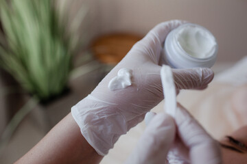 The girl lies on the coach, on a skin care procedure, improving her quality with a profesionak neautician