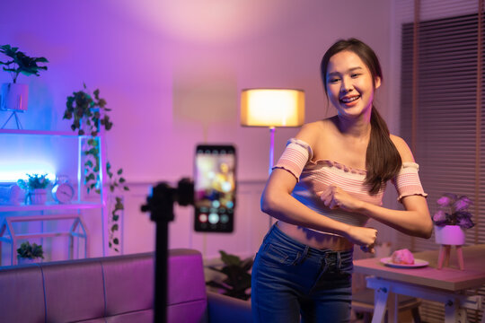 Asian Young Beautiful  Woman Streamer Listening To Music Dancing And Listening Music At Home Interior, Residential Building.