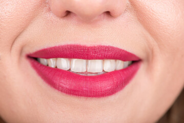 Fototapeta premium Woman Face With Pretty Smile and White Teeth. Studio Photo Shoot. Use Bright Red Lipstick.