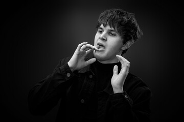 crazy young man with awesome hairdo grimacing