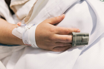 Close-up view of a patient with a pulse oximeter on finger at hospital.