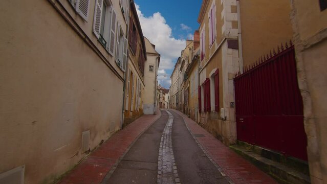 Video captures the view of a stunning street located in the center of Auxerre, showcasing the city's rich history and French legacy. Street with old traditional French houses