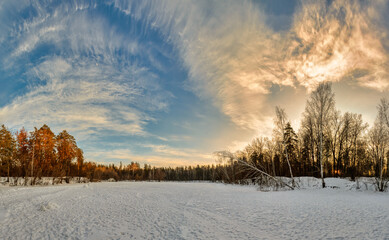 Sunset on the ice of the lake