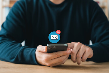 Email or newsletter concept, businessman using smartphone with email or newsletter notifications.
