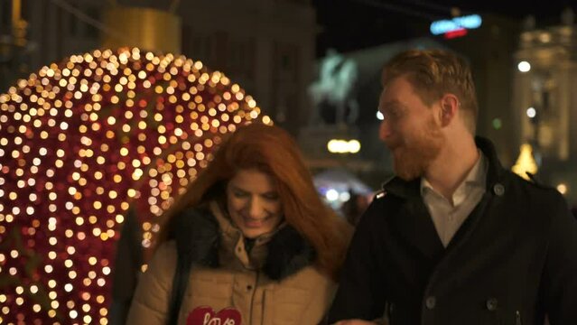 Winter holidays - happy young couple on Christmas evening, marriage proposal