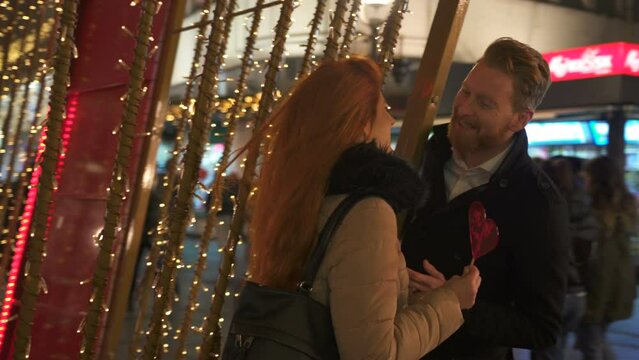 Winter holidays - happy young couple on Christmas evening, marriage proposal