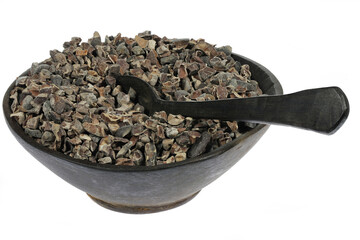 cocoa nibs in a wooden bowl with spoon isolated on white background