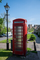 Close up of a traditional red UK telephone box in Bamburgh, UK