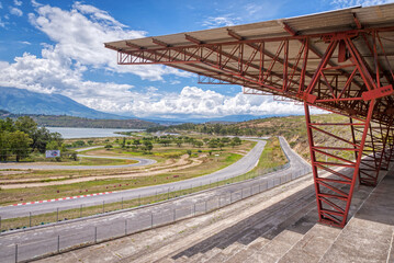 Fototapeta premium Abandoned Yahuarcocha race car circuit, with the Yahuarcocha lake in the background, on a beautiful sunny morning. Yahuarcocha, Imbabura province, Ecuador.