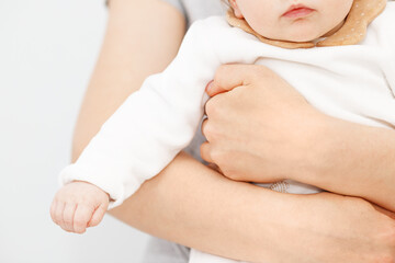 Mother holding of her newborn in hands. The baby on hands at mum. Childhood and baby care concept