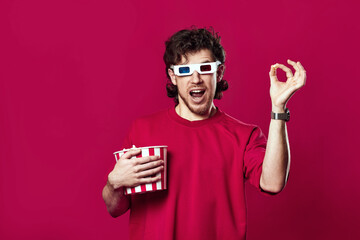 handsome bearded man in 3d-glasses, t-shirt showing popcorn