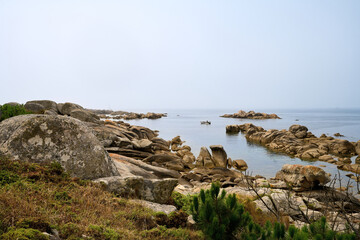 Galician beach with rocks and blue sky. Nature background.