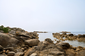 Fototapeta na wymiar Galician beach with rocks and blue sky. Nature background.