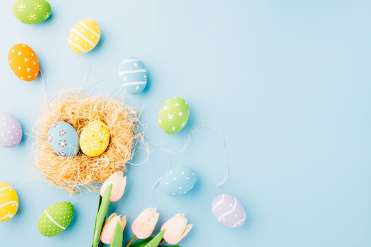 Happy Easter Day Concept. Top view of holiday banner background web design easter eggs in brown nest on white cement background with empty copy space, celebration greeting card, overhead, template