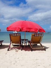 lounge chairs at the beach in the Caribbean. beautiful white sand and turquoise ocean