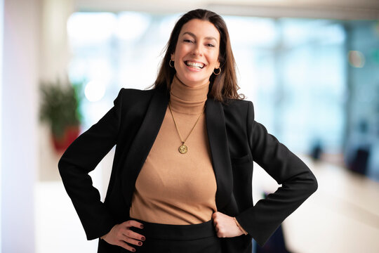 Attractive Middle Aged Businesswoman Standing With Hands On Hips At The Office