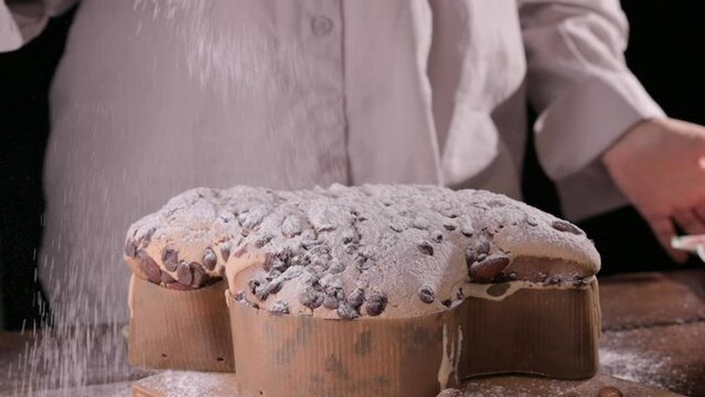 Colomba with chocolate. Easter Italian cake with almonds and chocolate in the shape of a dove. Festive pastries are traditional in Italy. High quality FullHD footage