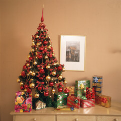 Living room of house at Christmas with table with food and champagne candles and chairs background gifts and tree, Christmas painted wall and wooden floor