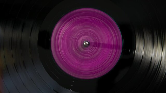 Black vinyl Retro with yellow color pink in center record on DJ turntable. 