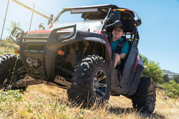 Off-Road Retiree: An Elderly Gentleman Enjoys Driving His Buggy in the Countryside