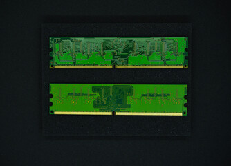 Green RAM strips on black foam. Computer chips close-up. Microchips and memory chips.