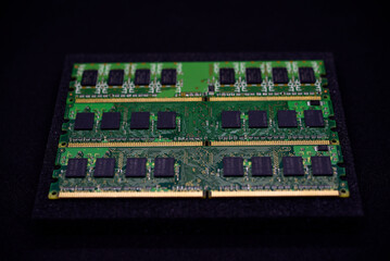 Green RAM strips on black foam. Computer chips close-up. Microchips and memory chips.