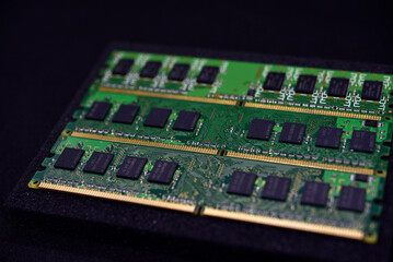 Green RAM strips on black foam. Computer chips close-up. Microchips and memory chips.