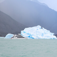 Boat passing iceberg in Patagonian waters
