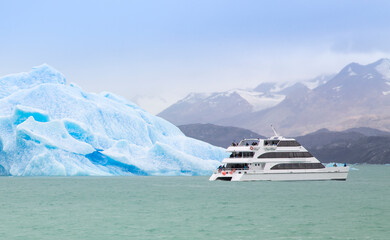 Boat passing iceberg in Patagonian waters