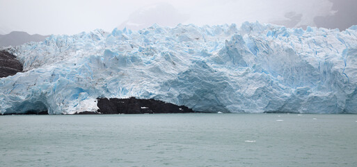 Glacier on the mountain in Patagonia with a lot of ice and green lake