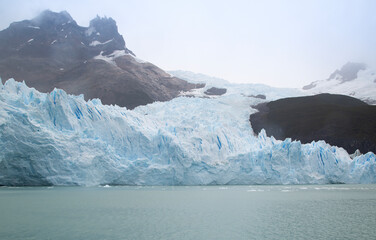 Glacier on the mountain in Patagonia with a lot of ice and green lake