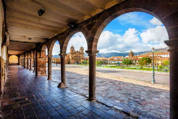 Main square of Cusco Old town from the traditional archways, Peru - obrazy, fototapety, plakaty