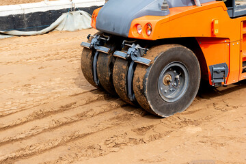 Fragment of pneumatic tire roller in the sand.