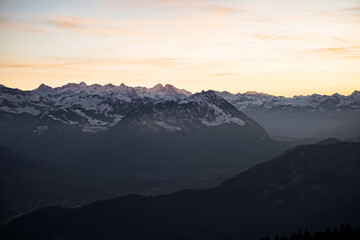 Fototapeta na wymiar Orange sunset on alpine mountains and lake 