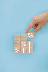 Interest rate and dividend concept, wooden block with percentage symbol and up arrow, return on...