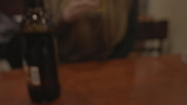 This POV video shows a couple making a celebratory toast with beer.