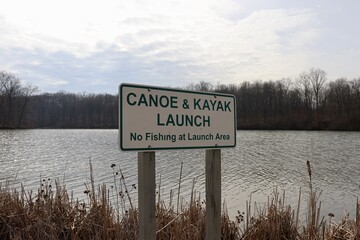 The green and white canoe kayak launch sign.