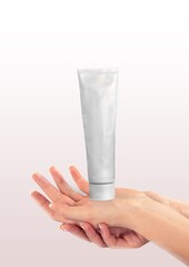 cosmetics cream tube on the woman's hand.