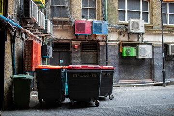 Garbage containers outside an alleyway